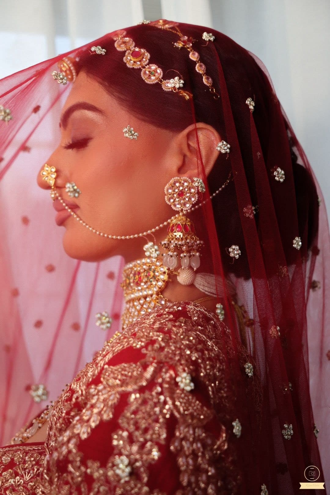 Bridal side profile with red veil